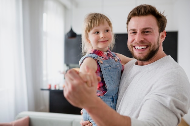 Premium Photo | Father with daughter looking at camera