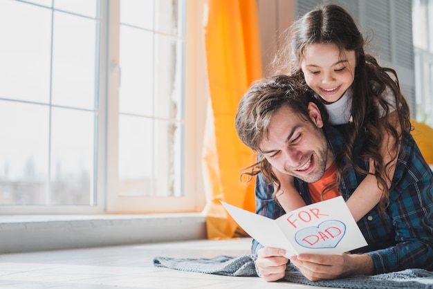 Fathers day concept with father reading in hand drawn card Free Photo
