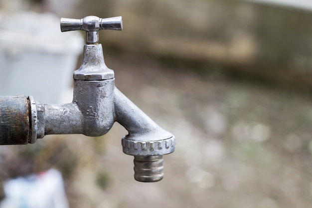 Premium Photo | Faucet at the fountain in the yard