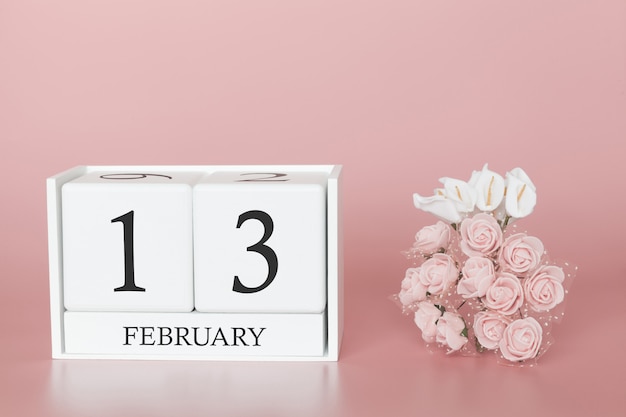 February 13th. day 13 of month. calendar cube on modern pink background, concept of bussines and an importent event. Premium Photo