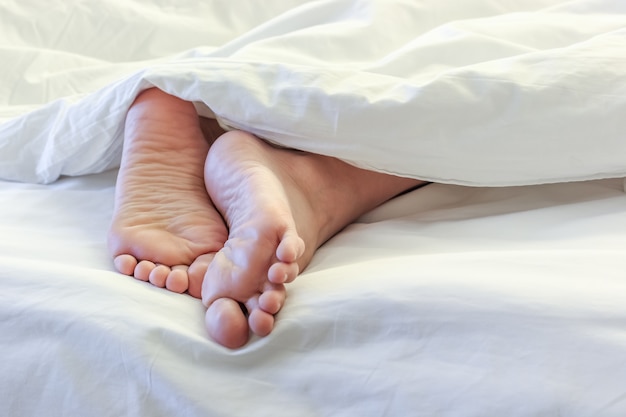 Premium Photo Feet Of Sleeping Woman In White Bedroom