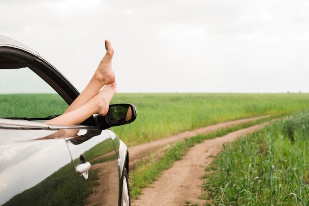 Free Photo Feet Of Woman Looking Out Of Car Window