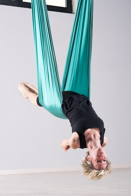 Premium Photo Female Athlete Doing Aerial Yoga Arm Stretches
