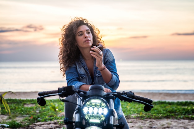 Premium Photo | Female biker driving a cafe racer motorbike