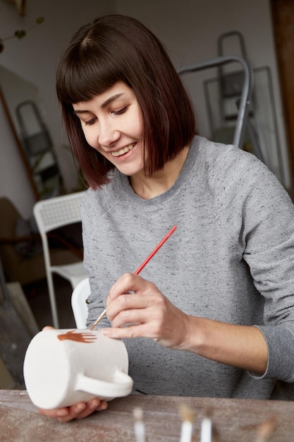 Premium Photo | Female ceramist working in pottery studio ceramists ...