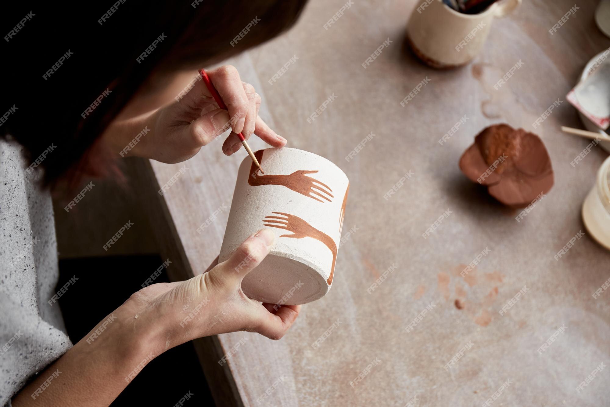 Premium Photo | Female ceramist working in pottery studio ceramists ...