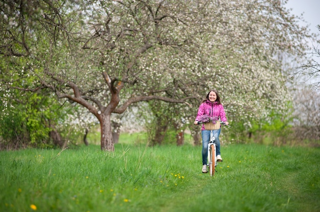 Premium Photo | Female cyclist riding a vintage white bicycle in spring ...