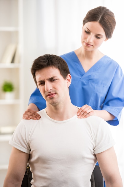 Premium Photo Female Doctor Making Neck Massage To Male Patient 