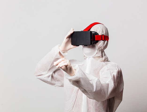 Premium Photo | Female doctor in protection suit and vr glasses with mask