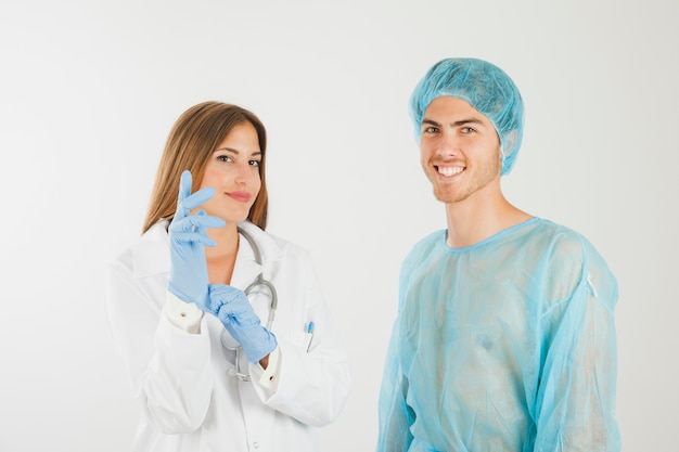 Female Doctor With Gloves Next To Smiling Patient Free Photo