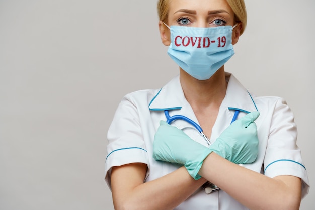 Female Doctor With Stethoscope Wearing Protective Mask And Latex Gloves