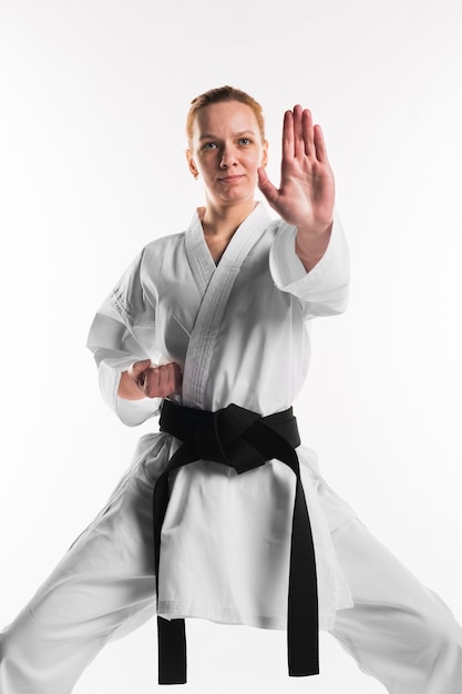 Female doing karate pose front view | Free Photo