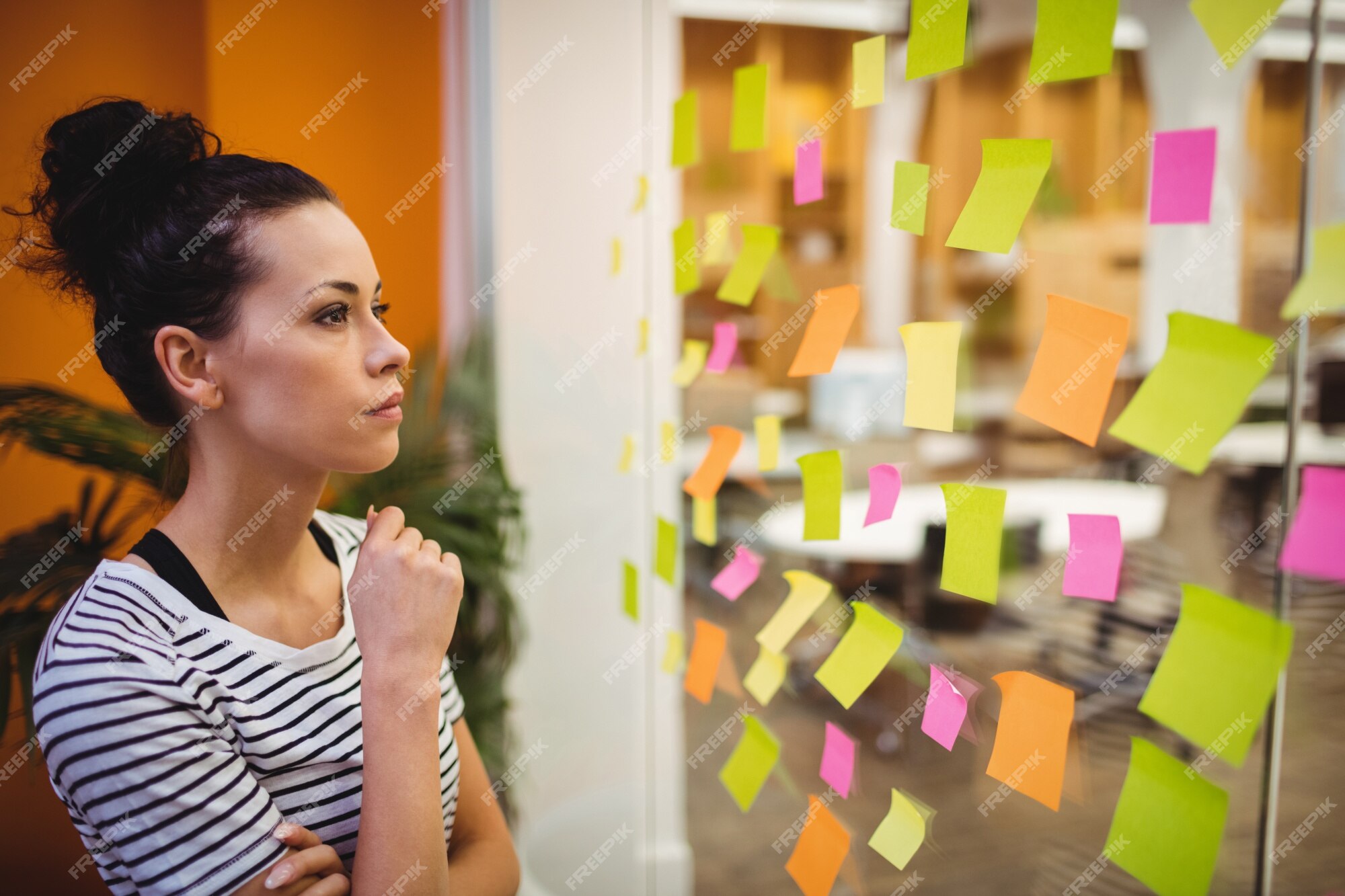 Free Photo | Female executive reading sticky notes