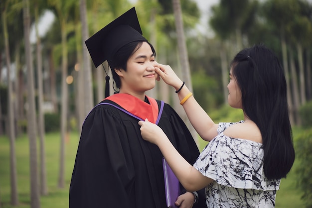 Premium Photo | Female graduate hugging each other with her friend ...