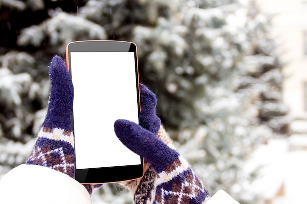 Premium Photo Female Hand In Mittens With Phone