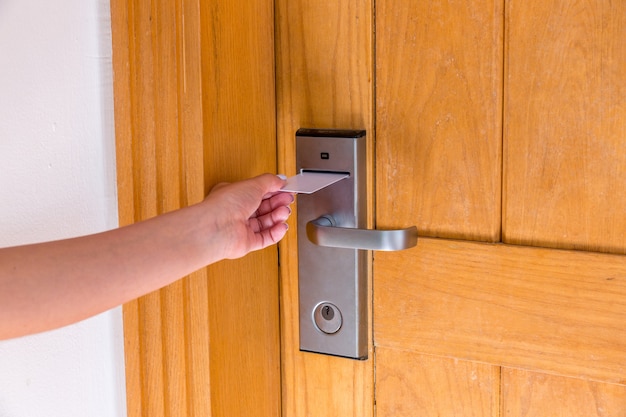 Premium Photo | Female hand putting and holding magnetic key card switch in  to open hotel room door