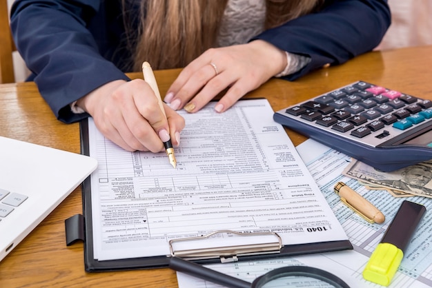 Premium Photo Female Hands Filling 1040 Form Taxation Concept