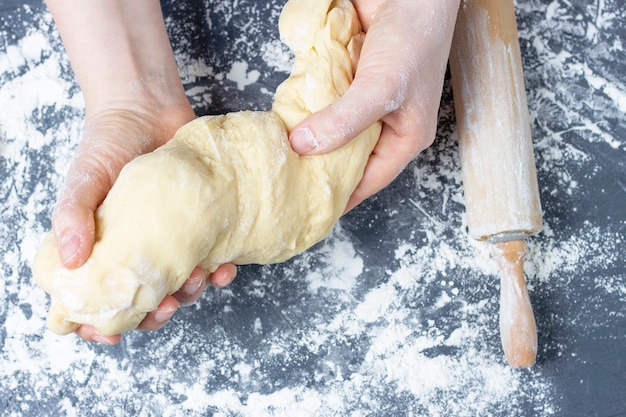 Premium Photo | Female hands twisting dough, concept in home baking