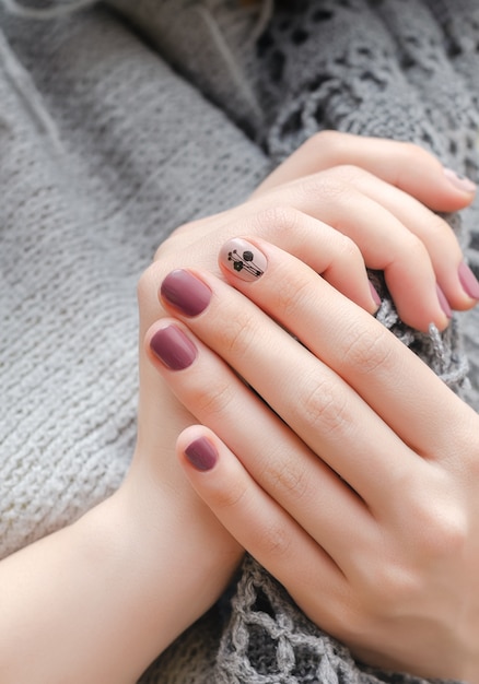 Premium Photo | Female hands with dark pink nail design
