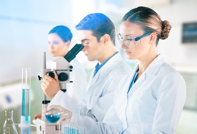 Premium Photo | Female and male scientists in glasses working