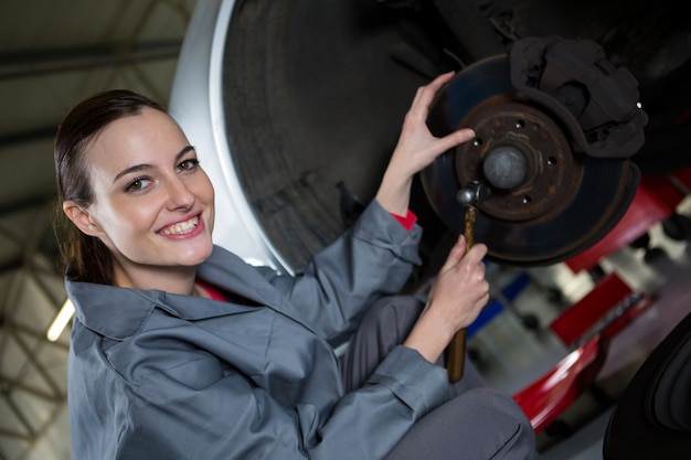 Female Mechanic Fixing Car Brake Free Photo