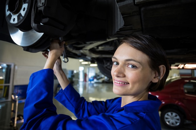 Free Photo Female Mechanic Fixing A Car Wheel Disc Brake