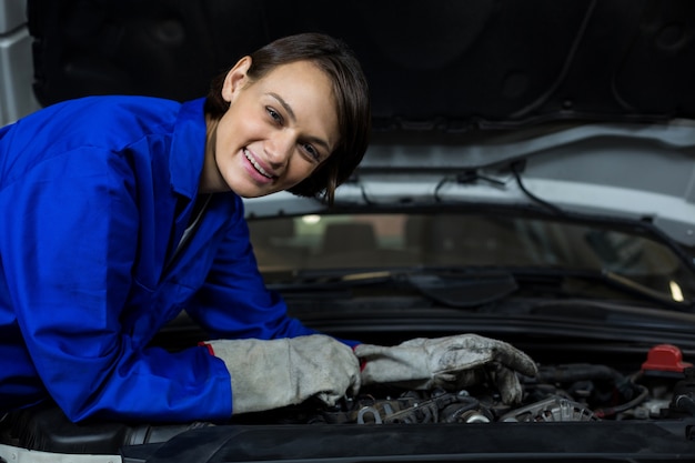 Free Photo Female Mechanic Smiling While Examining A Car