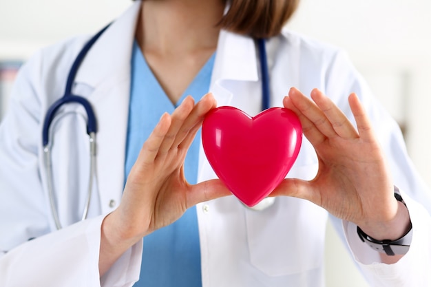 Premium Photo | Female medicine doctor hands holding red heart