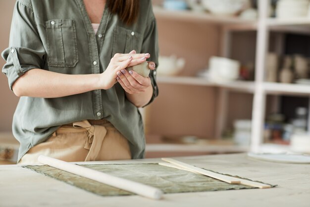 Premium Photo | Female potter shaping clay