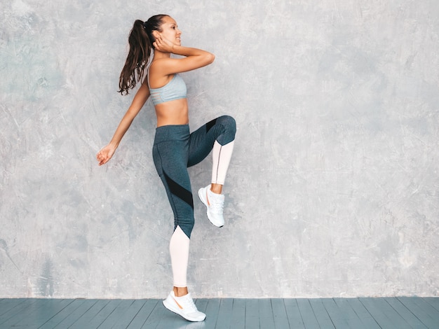 Female running in studio near gray wall Free Photo