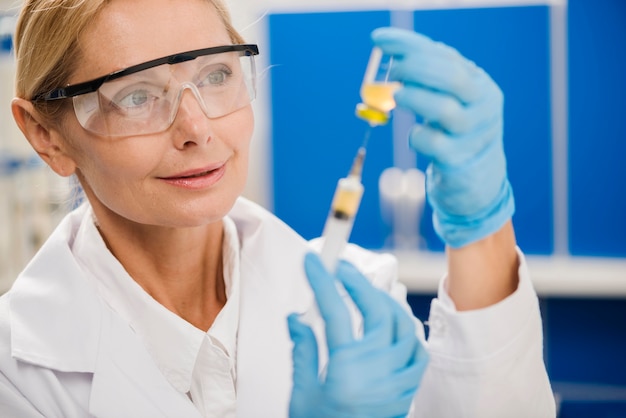 Free Photo | Female scientist using a syringe