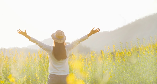 Female teen girl stand feel freedom and relaxation travel outdoor enjoying nature with sunrise. Free Photo