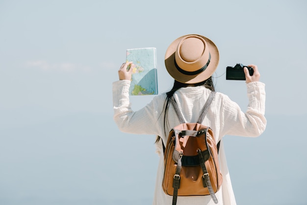 Female tourists spread their arms and held their wings Free Photo