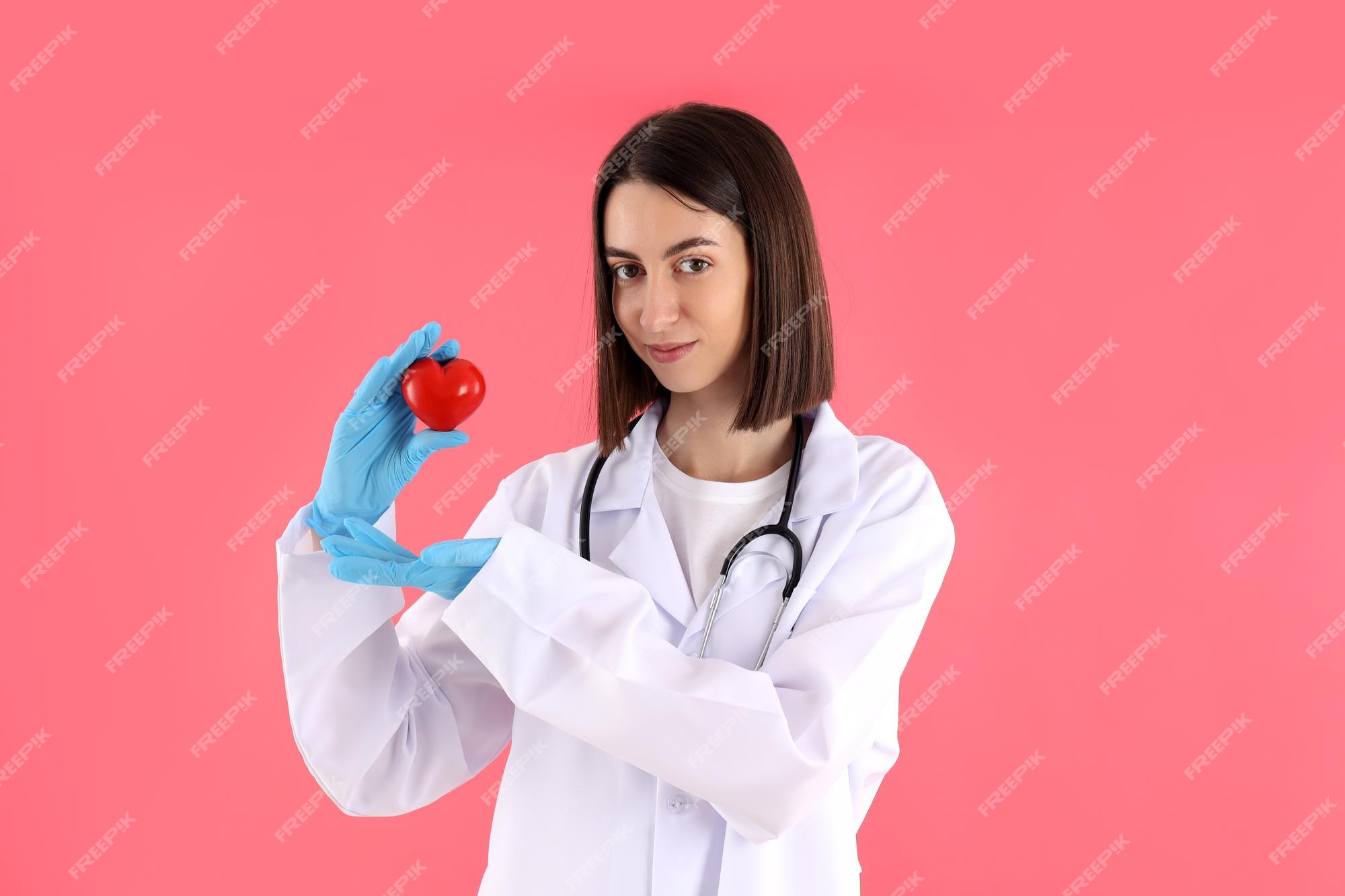 free-photo-female-trainee-doctor-with-heart-on-pink-background