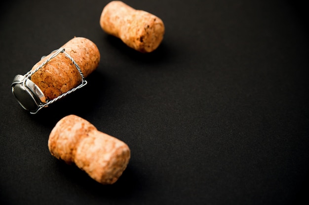 Premium Photo | A few champagne or wine corks on a black background.a