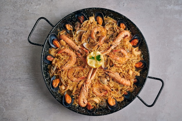 Premium Photo Fideua Noodle Paella With Seafood On Rustic Top View