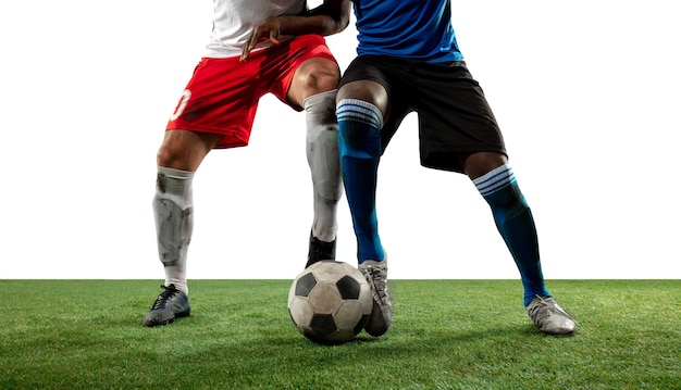 Fighting. close up legs of professional soccer, football players fighting for ball on field isolated on white wall. concept of action, motion, high tensioned emotion during game. cropped image. Free Photo