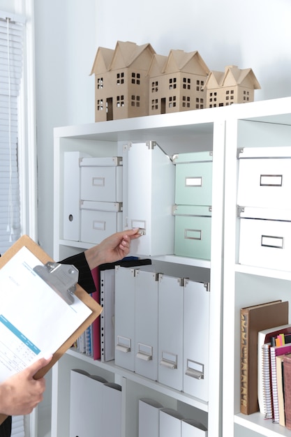 File folders, standing on shelves in the background Premium Photo