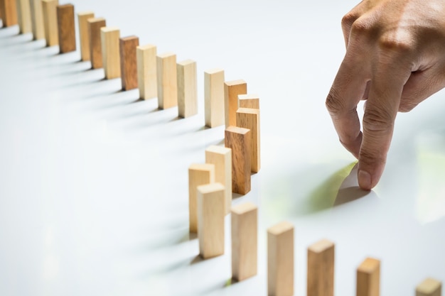 Finger like a business man and wooden block like reached an impasse, stalemate and solving a problem. Free Photo