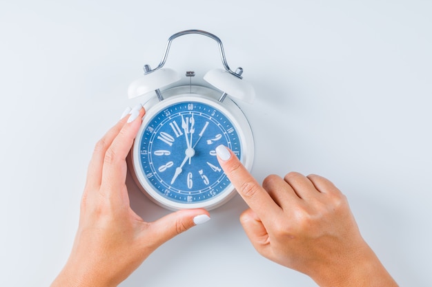 Finger pointing at alarm clock Free Photo