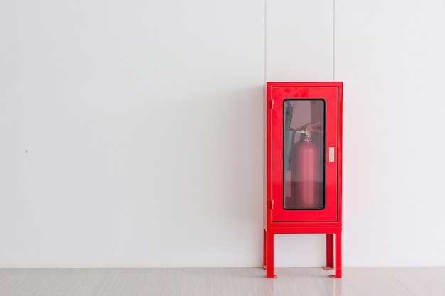 Fire extinguisher in red cabinet