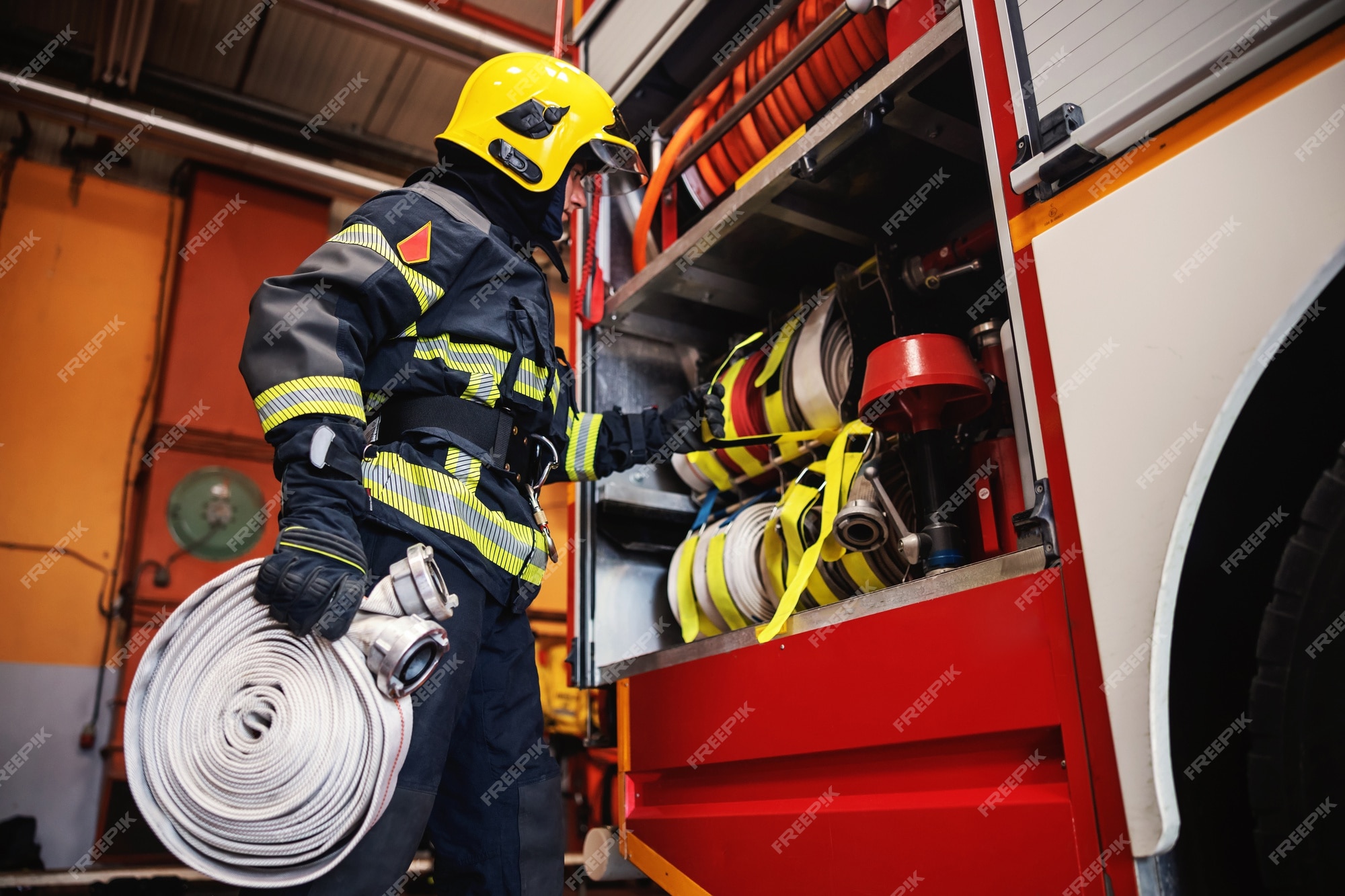 Premium Photo | Firefighter in protective uniform with helmet on head ...