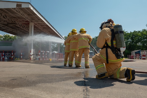 Premium Photo | Firefighters training with water hose