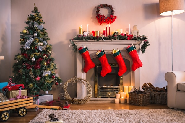 Fireplace With Red Socks Hanging And A Christmas Tree Free Photo