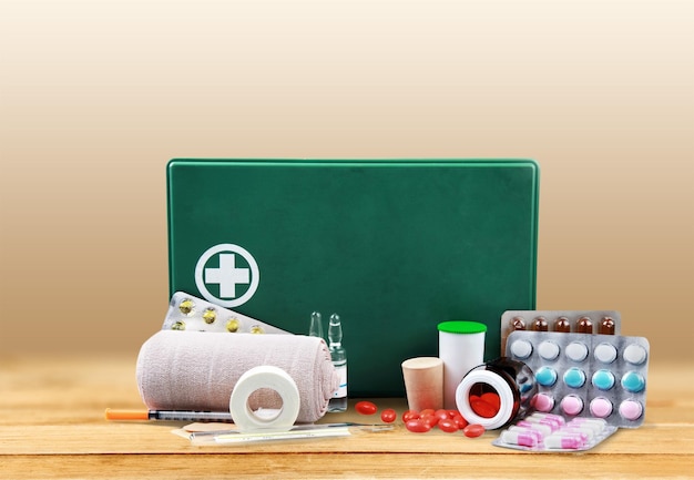 Premium Photo | First aid kit with medical supplies on light background