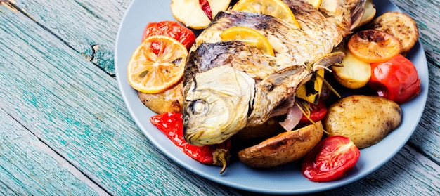 Premium Photo | Fish baked with vegetable garnish