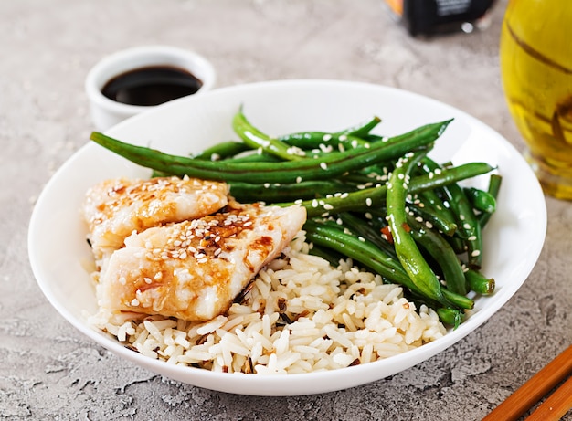 Premium Photo | Fish fillet served with rice, soy sauce and green beans