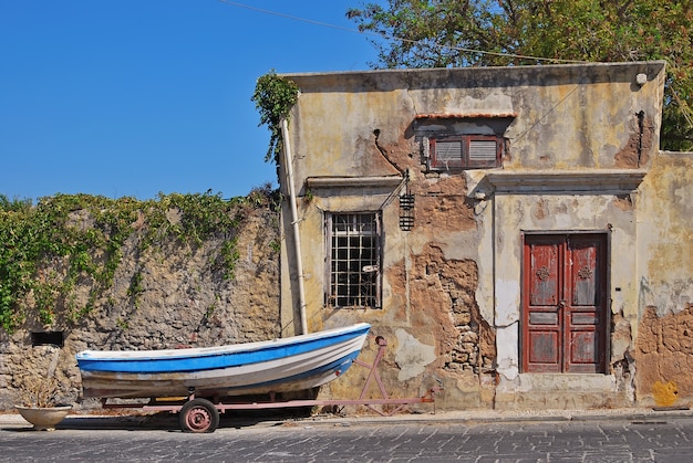 A fishing boat on a cart near the old house. rhodes, greece Premium Photo