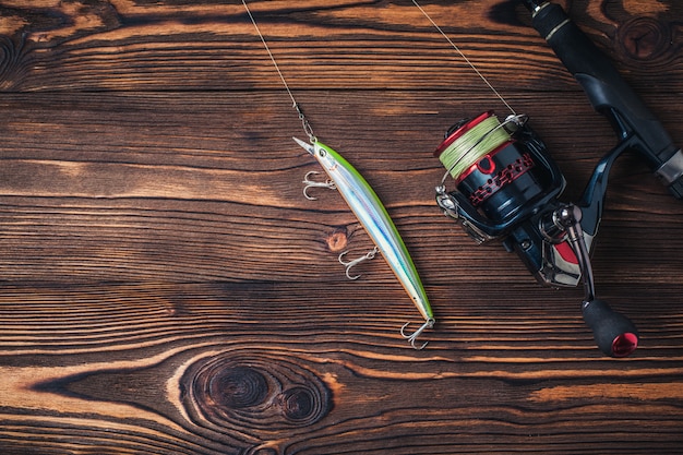 Fishing tackle on darken wooden background | Premium Photo