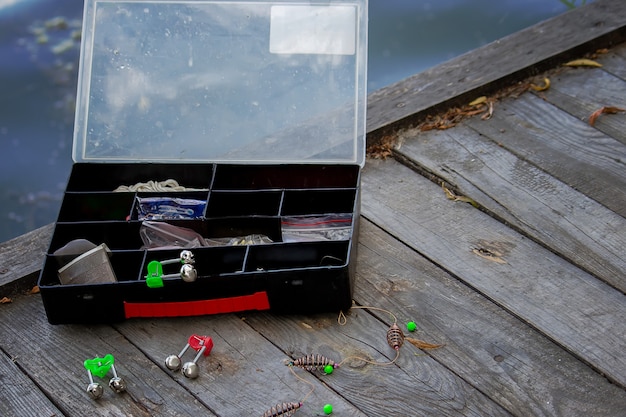 Premium Photo | Fishing tackle on the river bank, bait rod, spinning ...